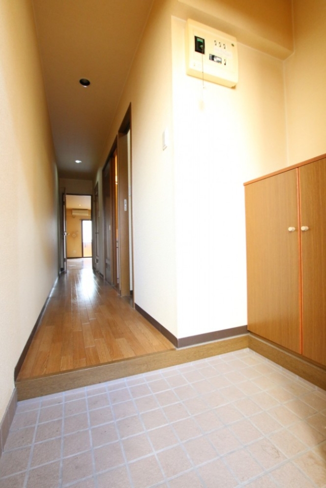 細長い廊下にキッチン、脱衣所と浴室、トイレの３つの扉があります。