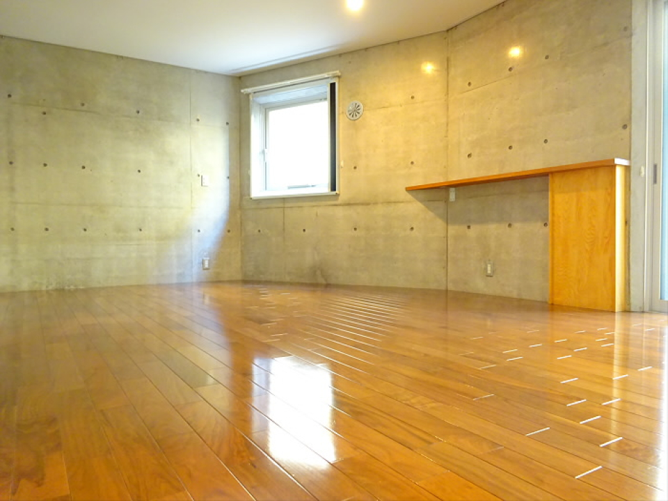 キッチン側から見ると木とコンクリートのおしゃれな組み合わせのお部屋